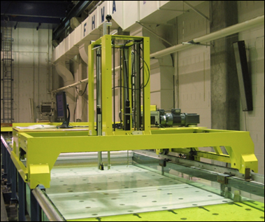 Figure 3. Photo. Automated flume carriage in the TFHRC Hydraulics Laboratory. This photo shows the flume carriage that is used for mounting a variety of measurement devices. The carriage moves longitudinally along the flume on side rails and also moves transversely.