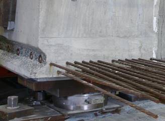 This photo shows a load cell under a beam at the west support. The load cell is located at the center of the beam. The beam is resting on a steel plate so that the entire width of the beam is supported.
