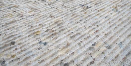 Figure 18. This photo shows the concrete bridge deck surface after scarification. The deck surface appears rough, and it is clear the scarification revealed the deck concrete internal course aggregate.