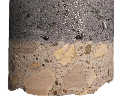 Figure 31-C. Photo. UHPC-concrete interface of G2-9 specimen after testing. This photo shows a closeup of the UHPC-concrete interface. Mode 4 failure is evident by a thin crack between the test disc and the UHPC overlay material. This viewshows that the bond between the UHPC overlay and the substrate concrete appears intact. Further, the texture of the existing concrete deck created by scarification is apparent.