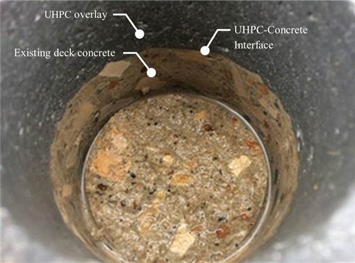 Figure 32. This figure shows a photo of the G2-9 core location after testing and removal of the test specimen. The UHPC overlay material appears to be bonded well to the existing deck concrete. This is evident because cracks do not exist at the UHPC-concrete interface.