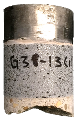 Figure 37-A. Photo. Front of G3-13 specimen after testing. This photo shows the front of the specimen. The steel test disc, UHPC overlay, and the substrate concrete can be observed. This specimen exhibits Mode 1 failure, which is failure within the substrate concrete.