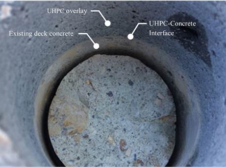 Figure 38. This figure is a photo of the G3-13 core location after testing and removal of the test specimen. The UHPC overlay material appears to be bonded well to the existing deck concrete. This is evident because cracks do not exist at the UHPC-concrete interface.