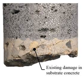 Figure 41-C. Photo. UHPC-concrete interface of B7-11 specimen after testing. This photo, shows a closeup of the UHPC-concrete interface. Subfigure B shows a cracking in the substrate concrete layer, which is further illustrated in this view, showing a closeup view of the UHPC-concrete interface. Although a crack is present, the bond between the UHPC overlay and the substrate concrete appears intact. Further, the texture of the existing concrete deck created by scarification is apparent. There is an arrow pointing to a line of existing damage with the words “Existing damage in substrate concrete deck.”