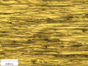 A scale bar is provided in the picture showing a dimension of 0.001 inch, and therefore the field of view is approximately 0.005 inch wide and 0.0038 inch tall. The image comprises two types of microstructures: light and dark. Both microstructures are elongated across the width of the image and alternately layered through the height of the image.