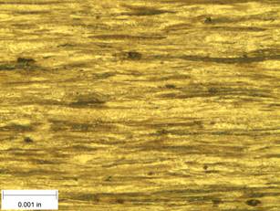 A scale bar is provided in the picture showing a dimension of 0.001 inch, and therefore the field of view is approximately 0.005 inch wide and 0.0038 inch tall. The image comprises two types of microstructures: light and dark. Both microstructures are elongated across the width of the image and alternately layered through the height of the image.