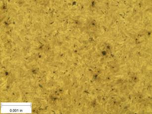 A scale bar is provided in the picture showing a dimension of 0.001 inch, and therefore the field of view is approximately 0.005 inch wide and 0.0038 inch tall. The image comprises two types of microstructures: light and dark. Both microstructures appear to be randomly distributed through the image and have grain sizes on the order of 0.0002 inch.