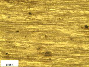 A scale bar is provided in the picture showing a dimension of 0.001 inch, and therefore the field of view is approximately 0.005 inch wide and 0.0038 inch tall. The image comprises two types of microstructures: light and dark. Both microstructures are elongated across the width of the image and alternately layered through the height of the image.