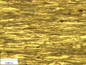 A scale bar is provided in the picture showing a dimension of 0.001 inch, and therefore the field of view is approximately 0.005 inch wide and 0.0038 inch tall. The image comprises two types of microstructures: light and dark. Both microstructures are elongated across the width of the image and alternately layered through the height of the image.