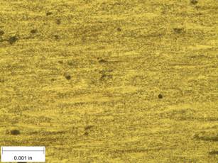 A scale bar is provided in the picture showing a dimension of 0.001 inch, and therefore the field of view is approximately 0.005 inch wide and 0.0038 inch tall. The image comprises two types of microstructures: light and dark. The microstructures appear to be evenly distributed, though there are faint signs of directionality from left to right.