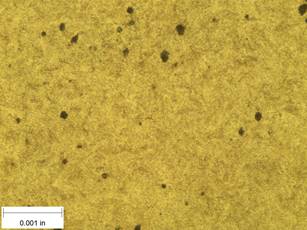 A scale bar is provided in the picture showing a dimension of 0.001 inch, and therefore the field of view is approximately 0.005 inch wide and 0.0038 inch tall. The image comprises two types of microstructures: light and dark. Both microstructures appear to be randomly distributed through the image and have grain sizes on the order of 0.0002 inch. The grain boundaries have started to become less defined and hard to distinguish at this magnification. The image also contains a random distribution of round inclusions, also around 0.0002 inch.