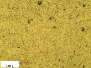 A scale bar is provided in the picture showing a dimension of 0.001 inch, and therefore the field of view is approximately 0.005 inch wide and 0.0038 inch tall. The image comprises two types of microstructures: light and dark. Both microstructures appear to be randomly distributed through the image, though their sizes are too small to distinguish at this level of magnification. The image also contains a random distribution of round inclusions, also around 0.0002 inch.