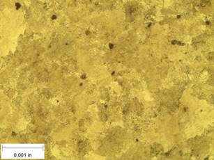 A scale bar is provided in the picture showing a dimension of 0.001 inch, and therefore the field of view is approximately 0.005 inch wide and 0.0038 inch tall. The image comprises two types of microstructures: light and dark. The grain sizes of the microstructures are quite large, on the order of 0.001 inch.