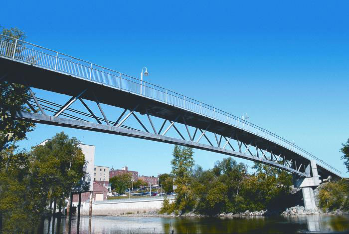 The photograph shows an elevation of the main span of the space truss bridge viewed from the waterway bank.