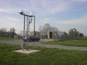Figure 3. The Hagerstown Ashtech and Trimble Antennas Photo. This photograph shows the two NDGPS equipment huts and the two antenna masts. Each antenna mast contains one GPS antenna and one integrity-monitoring antenna.
