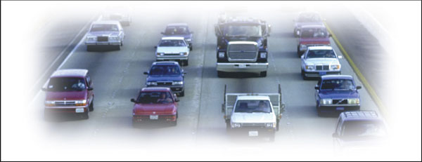 Photograph of traffic in multiple lanes facing toward the camera.