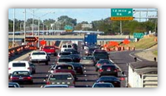 Image shows heavy or stopped traffic traveling along a three-lane highway. Traffic is a mix of personal cars and tractor trailers. A road sign above the traffic reads “644: Springfield/Franconia, ½ mile.”