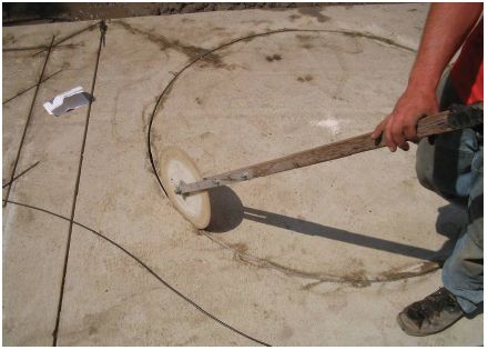 Figure 5-46. Firmly seating loop wire in sawcut with rolling-blade tool. The technician presses down on the wire with a circular wheel which is rolled around the sawcut on top of the loop wire. The pressure forces the wire to the bottom of the sawcut and firmly seats it there.