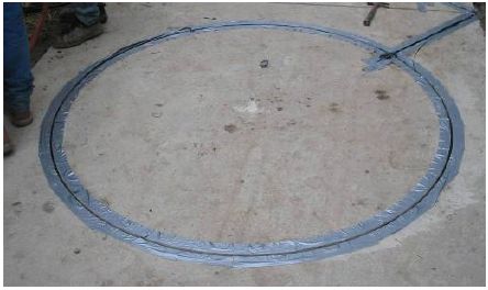 Figure 5-49. Tape placed around both sides of sawcut to prevent sealant from adhering to concrete. The technician places removable tape on the surface of the bicycle path. The excess sealant will adhere to the tape rather then the path surface, thus making the excess sealant easier to remove.