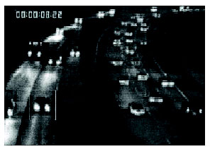 Figure 2-65. Visible spectrum CCD camera imagery of approaching traffic typical of dawn and dusk lighting. Photograph showing imagery typical of dawn or dusk lighting obtained with a charge-couple device (CCD) camera that might be used in a VIP system. Under these conditions, VIPs frequently key on vehicle headlights for detection.