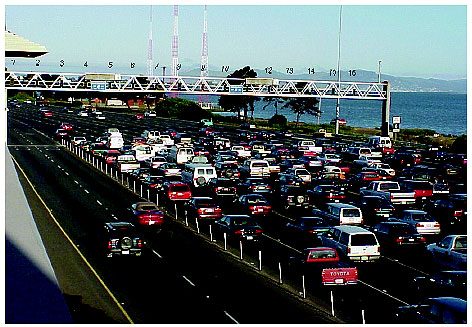 Figure 3-12. Mainline metering configuration on I-80 westbound crossing the San Francisco-Oakland Bay Bridge. Photograph of traffic in some 16 lanes as it approaches overhead gantry signals that control flow onto San Francisco-Oakland Bay Bridge.