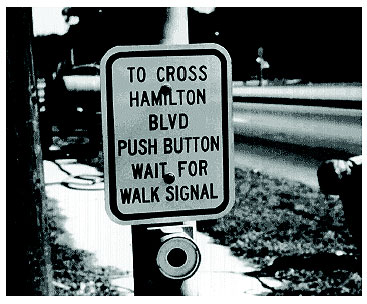 Figure 3-21. Manually operated pedestrian push button. Photograph of push button used to signal the controller to introduce a pedestrian crossing phase into the signal cycle.