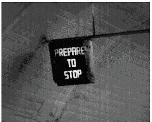 Figure 3-26. "PREPARE TO STOP" lighted sign. Photograph of a lighted "prepare to stop" sign in a tunnel.