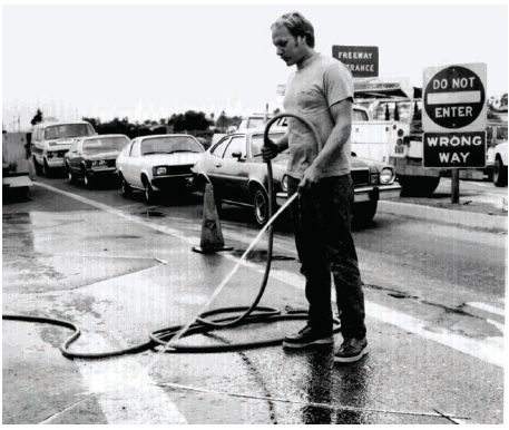 Figure 5-3. Pavement washing. Photograph of pavement washing after sawcut is made.