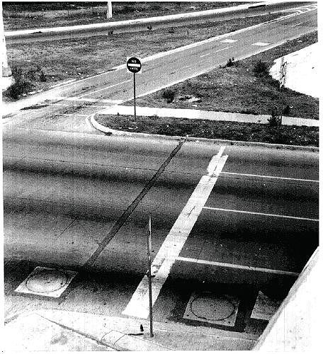 Figure 5-38. Slab loop installations. Photograph of installed wire precast slabs on an arterial in front of and behind a stopline. 