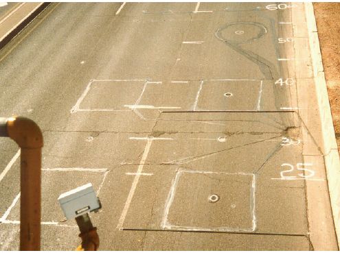 Figure 5-59. Down-lane road surface dimensions marked with paint as used for sensor evaluation and performance comparison. Photograph showing distances painted on roadway surface and use of paint to outline sensor locations. 