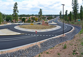 TThis is a photo of two cars using a roundabout