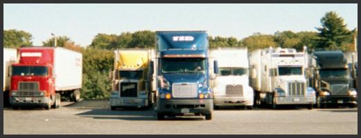 Figure 1. Example of tight parking for trucks.  Photo of a truck maneuvering into a narrow parking space.