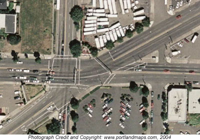 The aerial picture shows a busy multileg intersection with five roads converging and seven crosswalks of varying lengths. 