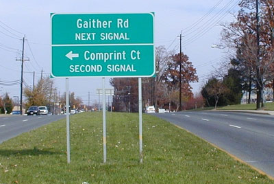 The picture shows a large advance sign that gives street names for the next two signalized intersections: the next signal is Gaither Road, and the second signal is Comprint Court.
