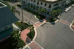 Figure 35. Photo. Curb extensions at intersections reduce crossing distance for pedestrians. The photo shows a four-way intersection with curb extensions on each corner.