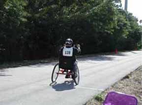 Figure 16. Photo. Pinellas Trail, St. Petersburg, FL. This photo shows the Pinellas Trail in St. Petersburg, FL. It is a paved trail in full sun with a trees on one side. One bicyclist is on trail. A data collection event was held here on January 25, 2003.