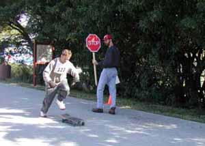 Figure 36: Photo. A skateboarder starting to accelerate. A participant is stepping onto his skateboard and preparing to leave the deceleration station.