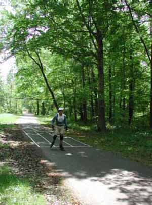 Figure 37: Photo. Sweep width station. A participant using inline skates has skated through the sweep width station. This section of trail is marked with longitudinal lines spaced 1 meter apart.