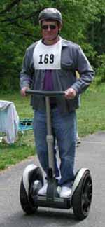 Figure 6: Photo. A Segway user. A man is using a Segway to travel on a trail.