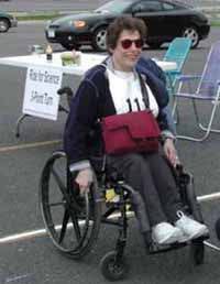 Figure 8: Photo. Another manual wheelchair. A woman is in a manual wheelchair in a parking lot.