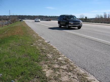 This picture of the Mobile Bay Causeway Road shows the four-lane roadway (two lanes in each direction). The features of this roadway are typical of a high-collision zone.