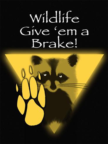 This is a picture of a poster. The poster colors are black, white, and yellow. There are white letters at the top of the poster on a black background that read “wildlife give ‘em a brake!” The lower portion of the poster shows a raccoon and a raccoon paw print in black and yellow.