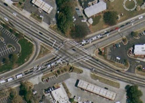 Figure 134. Photo. GoogleTM Map View of Briarcliff Rd & North Druid Hills Rd. This is a map view of Briarcliff Rd & North Druid Hills Rd, Dekalb County, Atlanta, GA. This is a skewed intersection with two approaches having right-turn bays. All four approaches have independent left-turn bays with lengths ranging from 32.94 m (108 ft) to 111.33 m (365 ft). The intersection is under semiactuated signal control and has three timing plans according to three peak-hour periods, AM peak, mid peak, and PM peak.