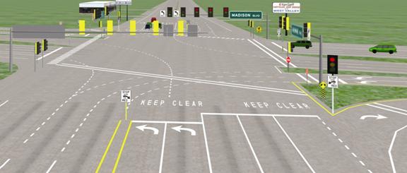 This is a scene from the driving simulation for the high treatment. The perspective is elevated so that the road markings can be seen more clearly. There is a stop line for three through lanes. To the left of that stop line is a stop line for two left-turn lanes. There are left arrows in each of the turn lanes. Just beyond each stop line the words "KEEP CLEAR" are painted on the pavement. To the left of the left-turn lane stop line, in a painted median, there is a STOP HERE sign. To the right of the stop line for the through lanes is a traffic signal. Below the traffic signal is a STOP HERE sign.