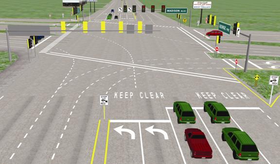 This is a scene from the driving simulation for the medium treatment. The picture is similar to figure 11, except the traffic signal to the right of the stop line in figure 11 is not present in this figure. Instead, the STOP HERE sign on the right side of the road is mounted on a pole.