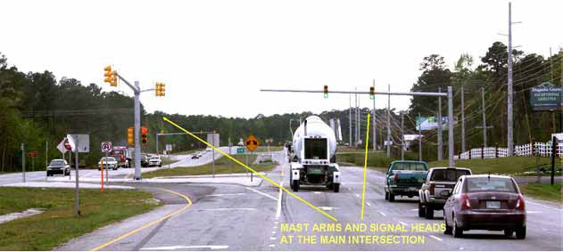 The photo has directional arrows indentifying mast arms and signal heads at the main intersection of a restricted crossing U-turn (RCUT) intersection at U.S. Route 17 in North Carolina.