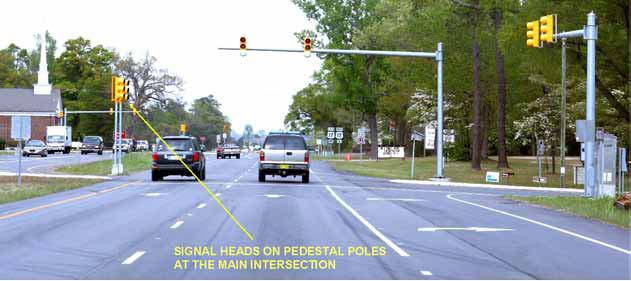 The photo has directional arrows identifying signal heads on pedestal poles at the main intersection of a restricted crossing U-turn (RCUT) intersection at U.S. Route 17 in North Carolina.