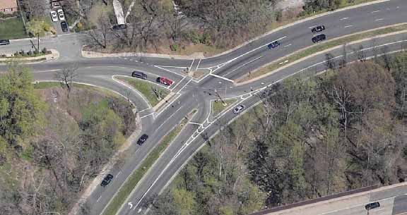 The photo provides an example of a continuous green T-intersection at the junction of Spout Run Parkway and Lorcom Lane in Arlington, VA.