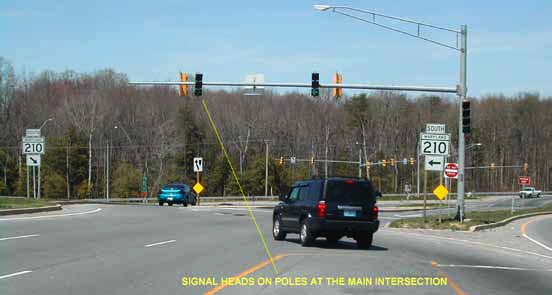 The photo has an arrow pointing to signal heads on poles at the main intersection of MD 210 and MD 228 in Accokeek, MD.