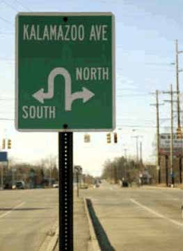 The photo shows an example of signing used at median U-turn (MUT) intersections in Michigan.